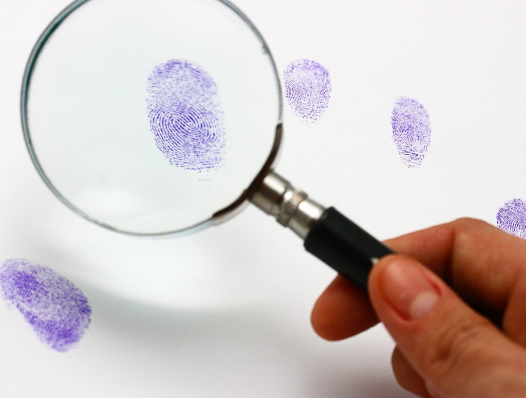 Police Examine A Fingerprint Left By A Suspect
