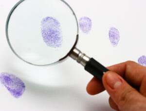 Police Examine A Fingerprint Left By A Suspect