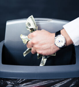 Businessman Hands Throwing Us Dollar Bills In Trash Bin
