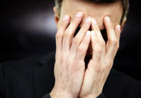 Frustrated man with hands on face