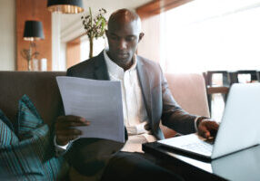 Businessman At Cafe Preparing Himself For A Meeting