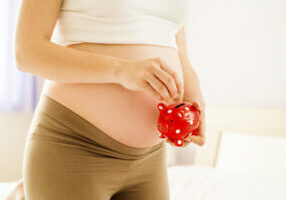Pregnant Woman With Piggy Bank